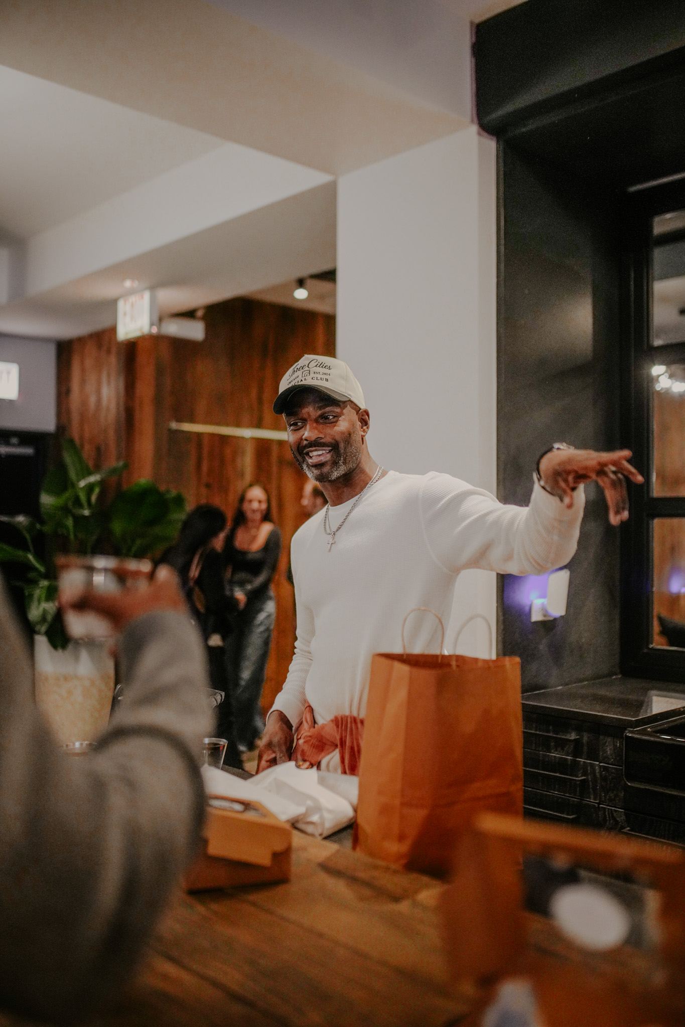 Draymond Washington in a Three Cities cap greeting members at the clubhouse front desk